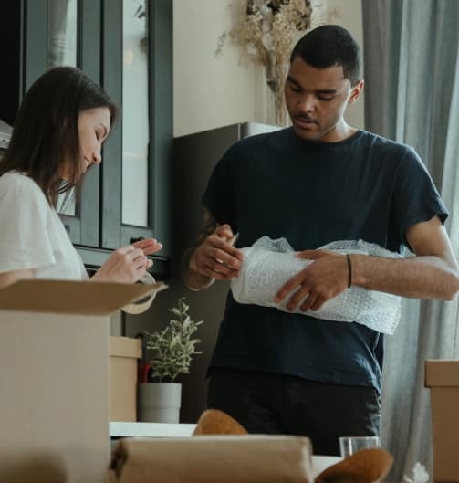 Couple getting ready to use the cheapest way to ship household goods